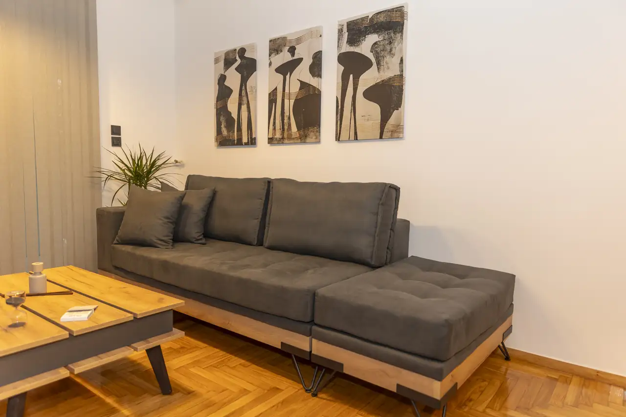 Living room at Where Dreams Attend: grey sofa, oak table and three framed prints