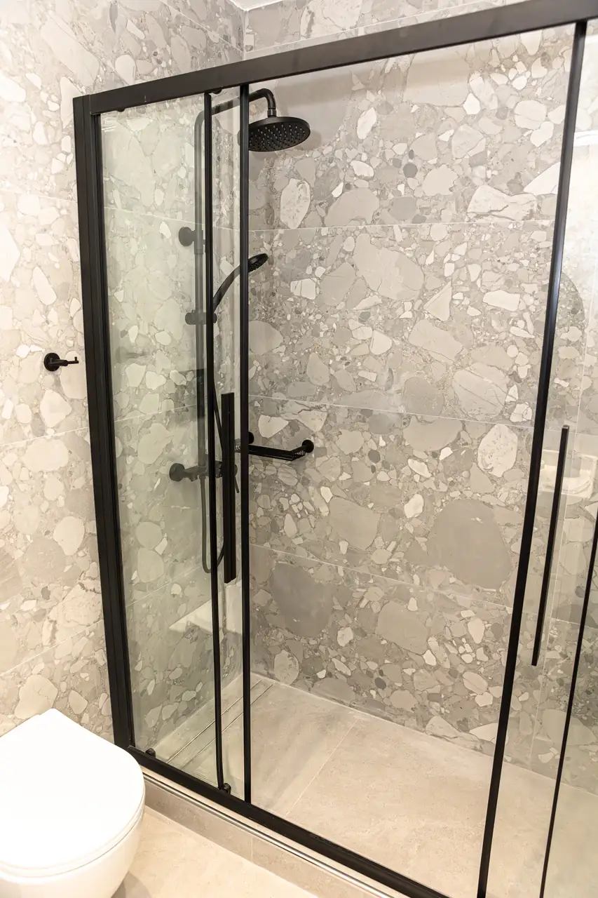 Walk-in shower with terrazzo tiles at Where Dreams Attend