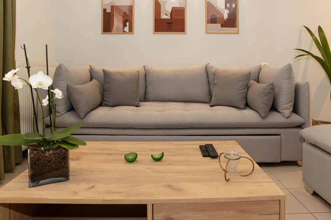Living room at Lycabettus Athens: linen sofa, oak coffee table and orchids