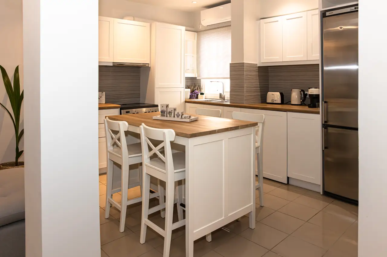 Kitchen with white cabinets and island