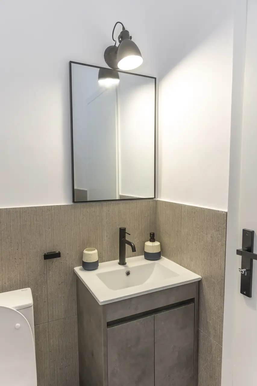Bathroom with washbasin and wall lamp at Lycabettus Athens